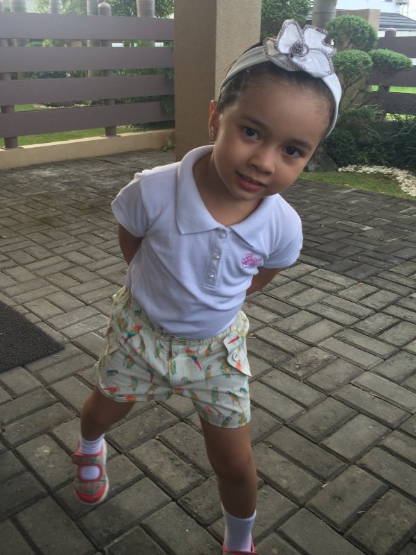 Alba in a pose remenisent of a store cleck asking 'May I help you'