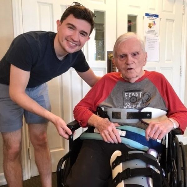 Sean with Paul in a wheel chair at his home
