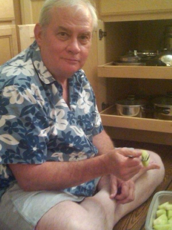 Mark on the floor in his kitchen imitating Alba at 3 with all the pots pulled of of the cabinet