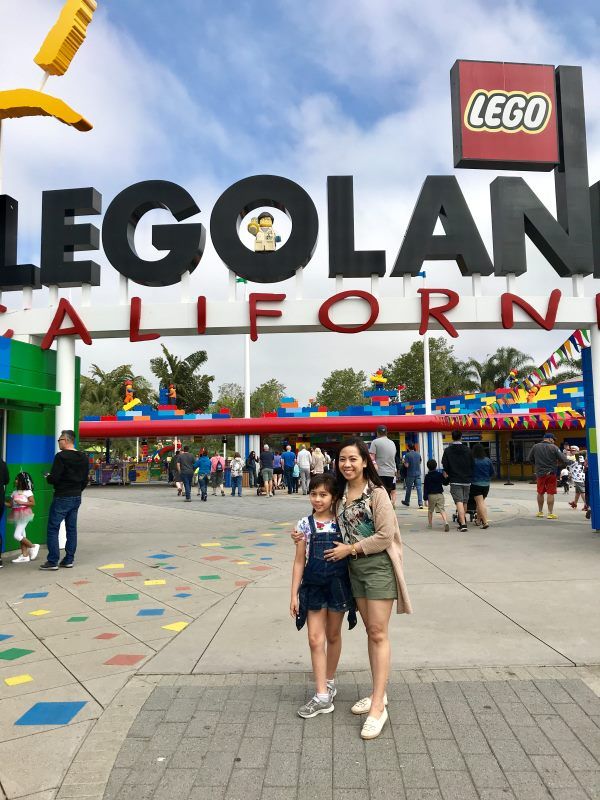 Cher and Alba in front of the Legoland San Diego sign